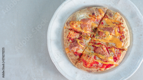Delicious pizza with sausages on wooden background, top view