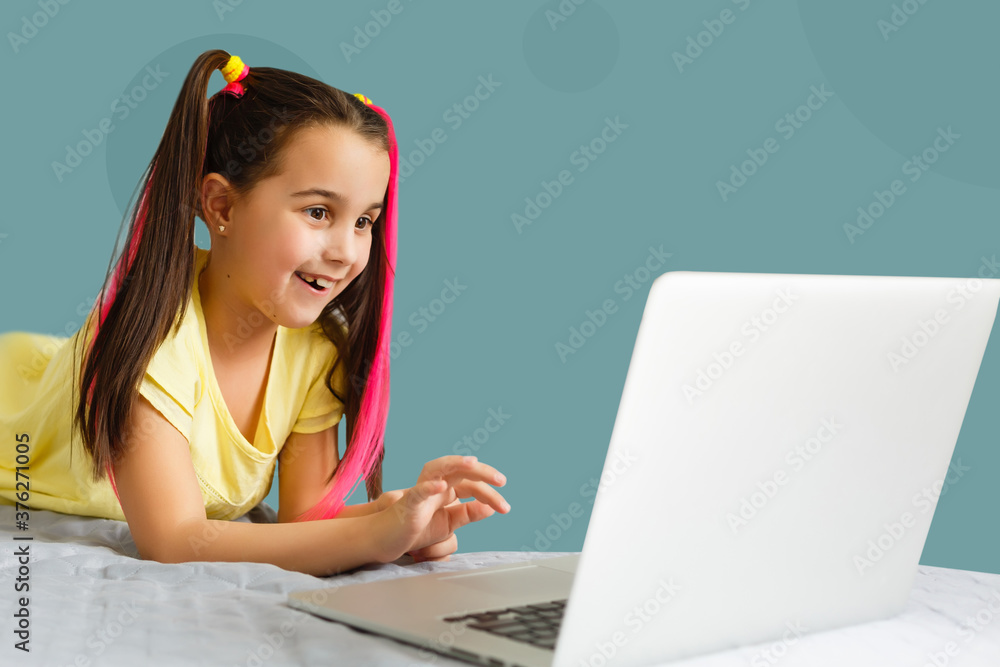 Cute little girl using laptop at home. Education, online study, home studying, distance learning, schoolgirl children lifestyle concept Cute little girl using laptop at home. Education, online study, home studying, distance learning, schoolgirl children lifestyle concept