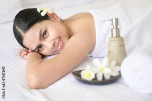 A beautiful woman is relaxing and having massage in spa resort, Massage and beauty treatment concept.