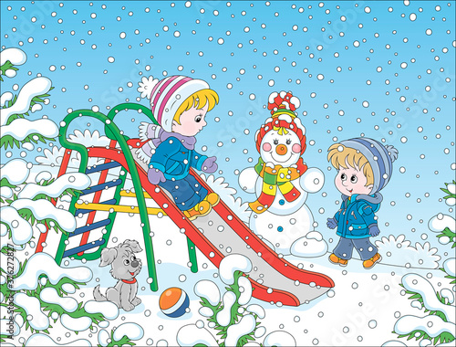 Kids playing on a toy slide on a snow-covered playground in a winter park on a snowy day, vector cartoon illustration