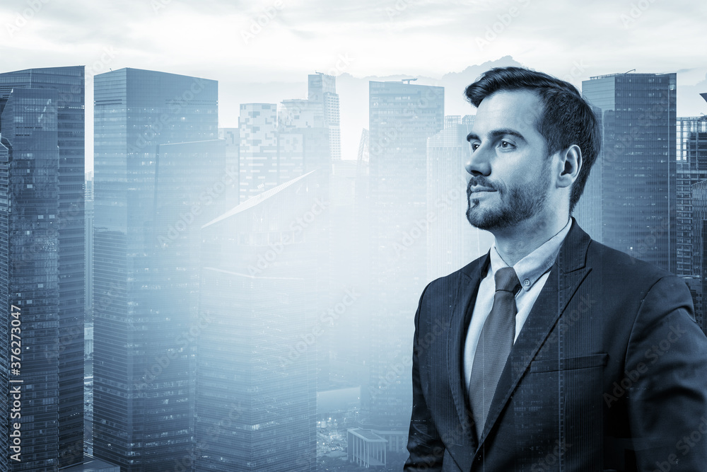 Young handsome businessman in suit thinking how to succeed, new career opportunities, MBA. Singapore on background. Double exposure. Young handsome businessman in suit thinking how to succeed, new career opportunities, MBA. Singapore on background. Double exposure.