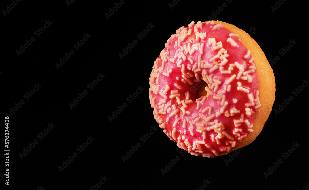 Flying pink glazed donut with sprinkles. Flying pink glazed donut with sprinkles.