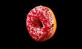 Flying pink glazed donut with sprinkles.