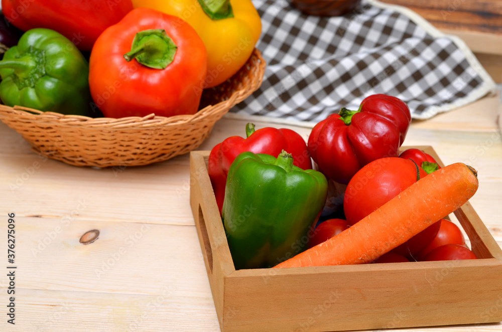 box with fresh vegetables in the kitchen carrots and bell peppers and tomatoes box with fresh vegetables in the kitchen carrots and bell peppers and tomatoes