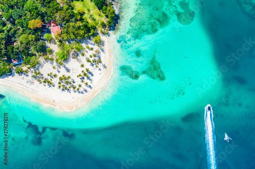 Aerial drone view of beautiful caribbean tropical island Cayo Levantado beach with palms and boats. Bacardi Island, Dominican Republic. Vacation background.