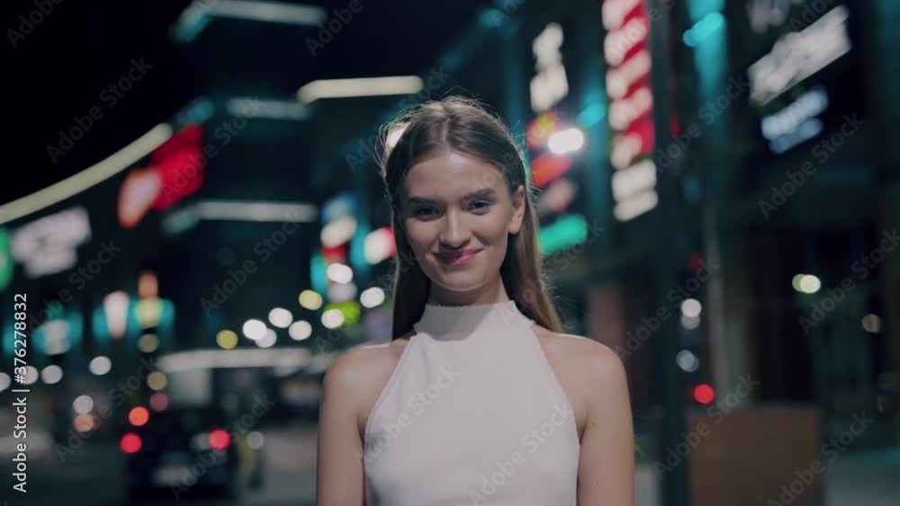Beautiful woman with attractive face features looking at camera showing charming and cheerful smile. Female portrait. Lovely caucasian girl. Emotions. Cityscape. Beautiful woman with attractive face features looking at camera showing charming and cheerful smile. Female portrait. Lovely caucasian girl. Emotions. Cityscape.