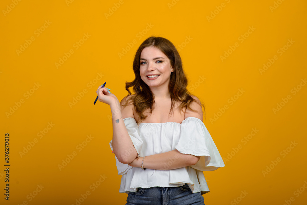 Cheerful young female in formal wear holding pen and smiling Cheerful young female in formal wear holding pen and smiling