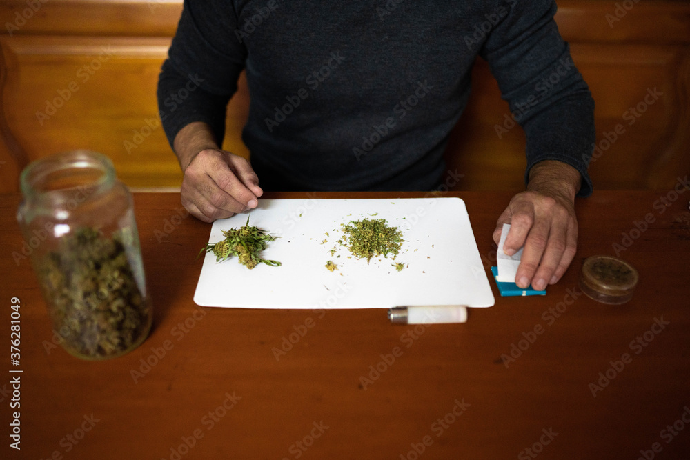 Foto de Preparing a joint and drug paraphernalia concept theme with
