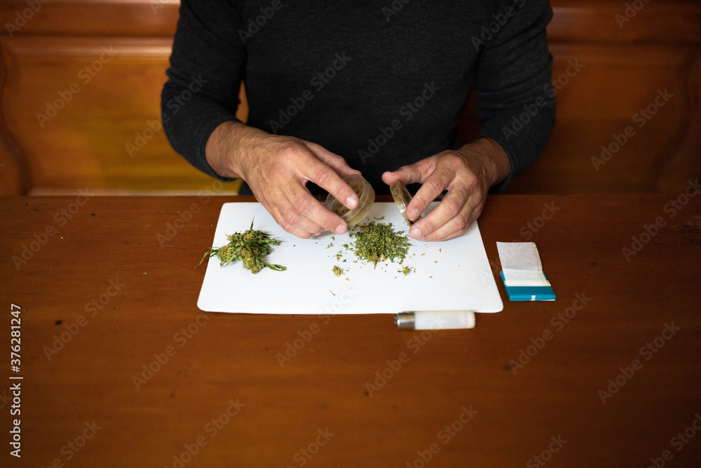 Preparing a joint and drug paraphernalia concept theme with herb girder