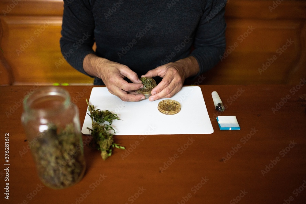 Foto de Preparing a joint and drug paraphernalia concept theme with