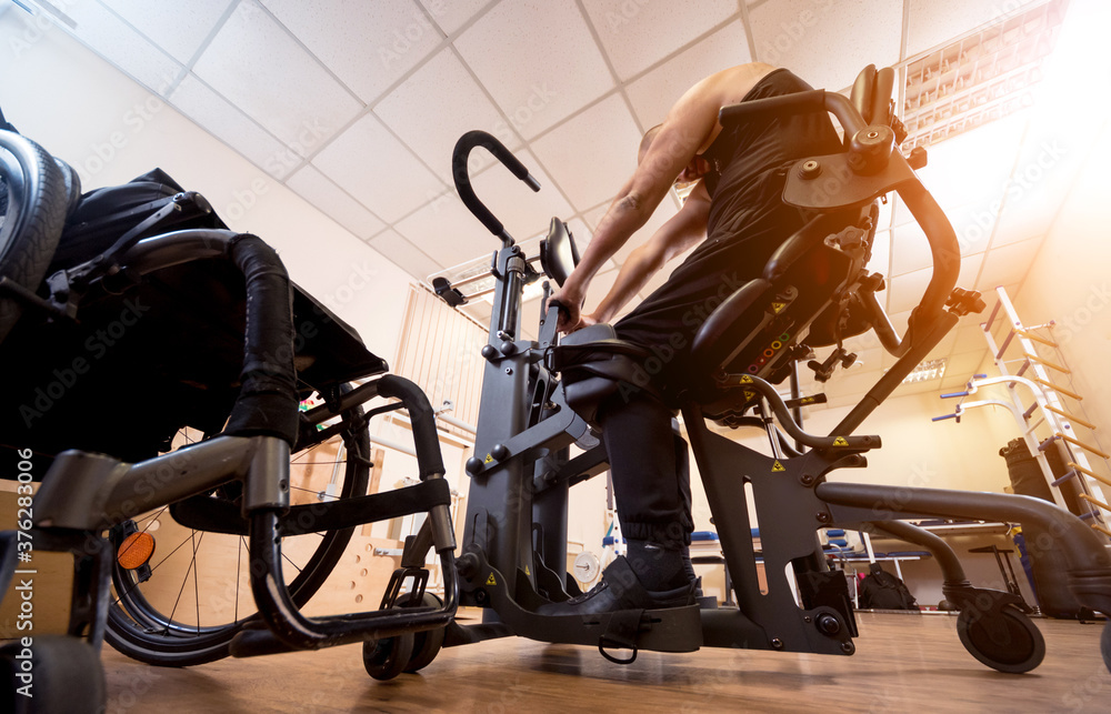 Disabled man training in the gym. Rehabilitation center
