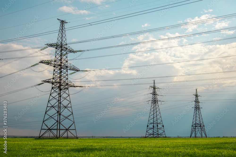 © es0lex - High voltage lines and power pylons in a flat and green agricultural landscape on a sunny day with clouds in the blue sky. Cloudy and rainy. Wheat is growing © es0lex - High voltage lines and power pylons in a flat and green agricultural landscape on a sunny day with clouds in the blue sky. Cloudy and rainy. Wheat is growing