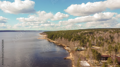 Aerial view of the Vuoksi river, the forest and the settlement in autumn day, Losevo, Leningrad Oblast, Russia