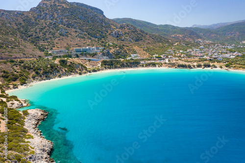 Aerial view of the beautiful sandy beach and crystal clear waters of Voulisma Beach, Crete, Greece © whitcomberd