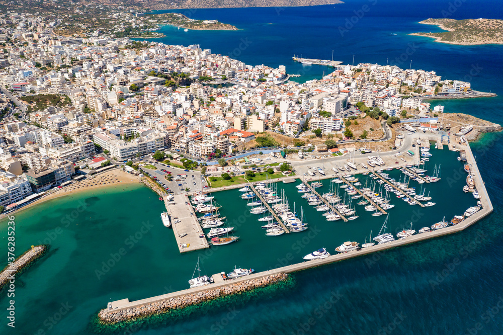 Aerial view of the marina and beautiful Cretan town of Agios Nikolaos on the shores of the Aegean Sea (Crete, Greece)