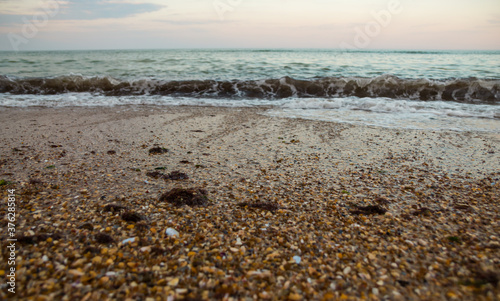 Beautiful waves on the sea beach in the evening. Sea sunset. Sunset over the sea beach