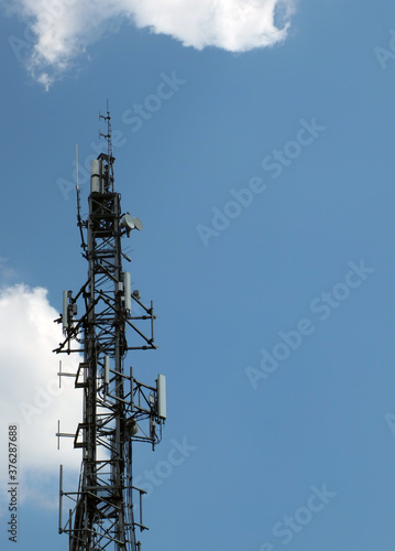Fotografija telecommunication mast with mobile phone antennas relay equipment and terrestria