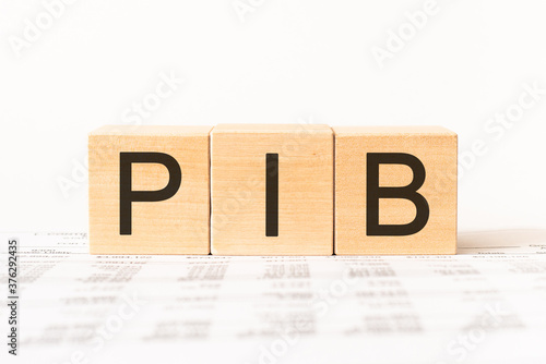 Word PIB. Wooden small cubes with letters isolated on white background with copy space available.Business Concept image. photo