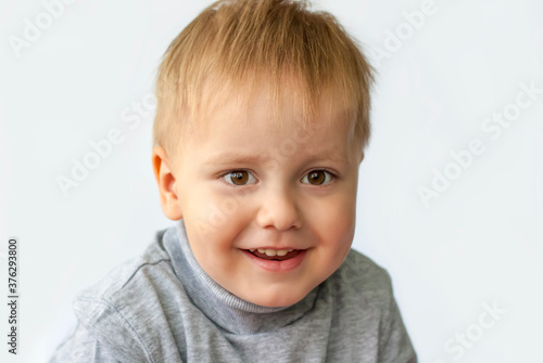 Portrait of an astonished cute little boy. The child is isolated on a white background. Success, bright idea, creative ideas and innovative technological concepts. Concept for an advertising banner.