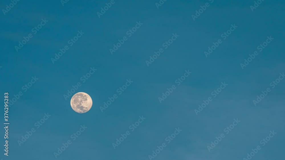 Close-up setting full moon moves in the blue sky at sunrise. 4k time-lapse Close-up setting full moon moves in the blue sky at sunrise. 4k time-lapse