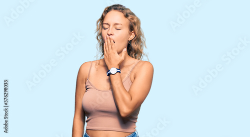 Beautiful caucasian woman wearing casual clothes bored yawning tired covering mouth with hand. restless and sleepiness.