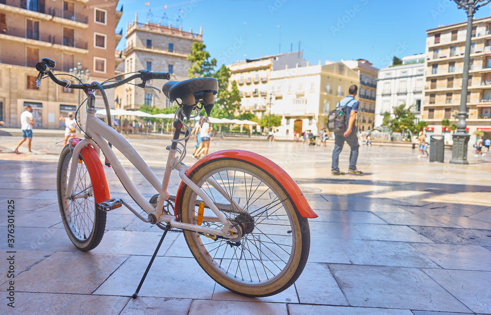 Fototapeta premium Bicycle parked on a city street. Cycling or commuting in the urban environment, ecological transport concept.