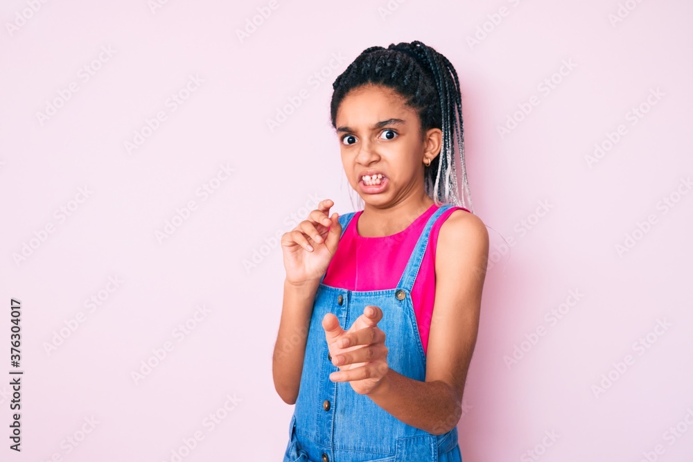 Young african american girl child with braids wearing casual clothes over pink background disgusted expression, displeased and fearful doing disgust face because aversion reaction. with hands raised Young african american girl child with braids wearing casual clothes over pink background disgusted expression, displeased and fearful doing disgust face because aversion reaction. with hands raised