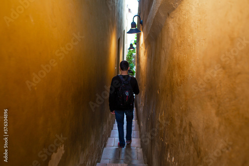 The architecture of the strago city of Prague. The narrowest street in Europe. The passage between buildings for one person  regulated by traffic lights