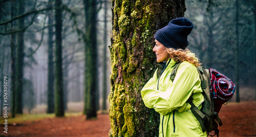 Beautiful woman enjoy the forest wood in outdoor leisure activity - backpack travel and adventure lifestyle - autumn season people enjoying nature and healthy life in a foggy outdoors Beautiful woman enjoy the forest wood in outdoor leisure activity - backpack travel and adventure lifestyle - autumn season people enjoying nature and healthy life in a foggy outdoors