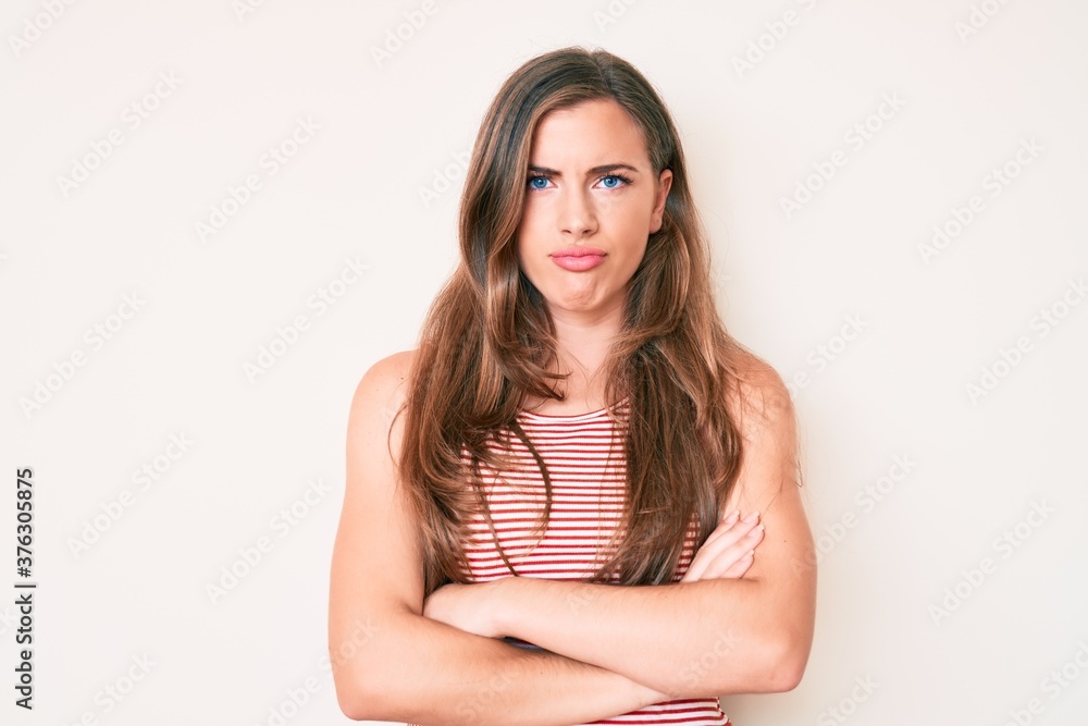 Beautiful young caucasian woman wearing casual clothes skeptic and nervous, disapproving expression on face with crossed arms. negative person. Beautiful young caucasian woman wearing casual clothes skeptic and nervous, disapproving expression on face with crossed arms. negative person.