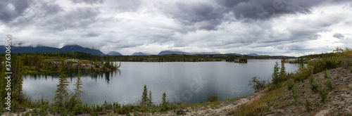 Panoramic Beautiful View of Lewes Lake during a cloudy summer day. Located near Whitehorse, Carcross, Yukon, Canada. Nature Background Panorama