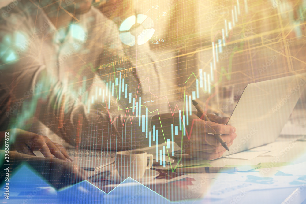 Multi exposure of man and woman working together and financial chart hologram. Business concept. Computer background. Multi exposure of man and woman working together and financial chart hologram. Business concept. Computer background.