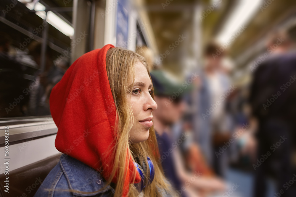 Beautiful woman in car of train in metro.