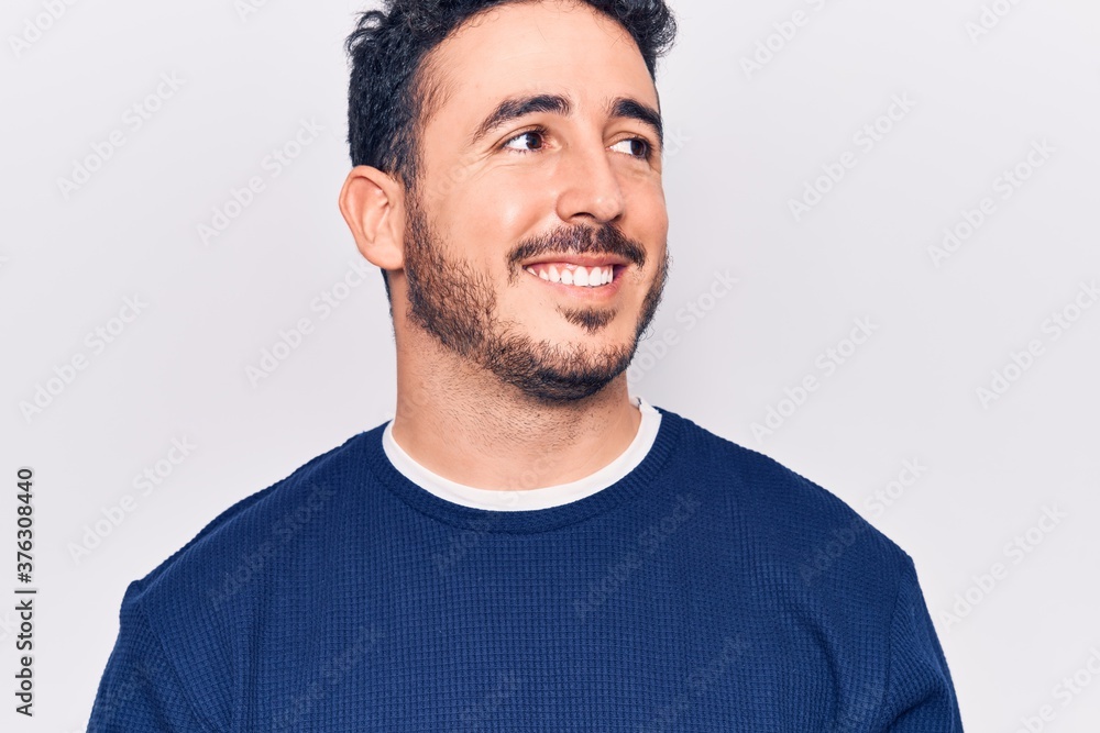 Obraz premium Young hispanic man wearing casual clothes looking to side, relax profile pose with natural face and confident smile.