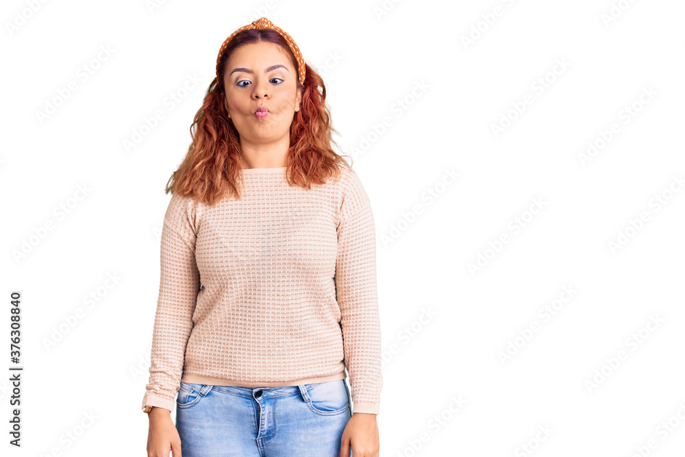 Young latin woman wearing casual clothes and diadem making fish face with lips, crazy and comical gesture. funny expression. Young latin woman wearing casual clothes and diadem making fish face with lips, crazy and comical gesture. funny expression.