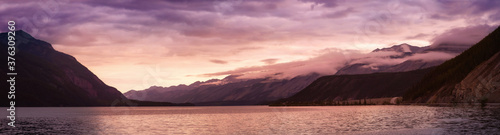 Beautiful Panoramic View of Muncho Lake in the Canadian Northern Rockies during a cloudy sunrise. Taken in British Columbia  Canada. Nature Background Panorama