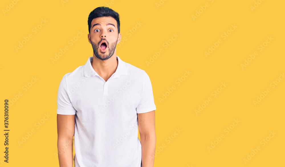 Young handsome hispanic man wearing casual clothes afraid and shocked with surprise and amazed expression, fear and excited face. Young handsome hispanic man wearing casual clothes afraid and shocked with surprise and amazed expression, fear and excited face.