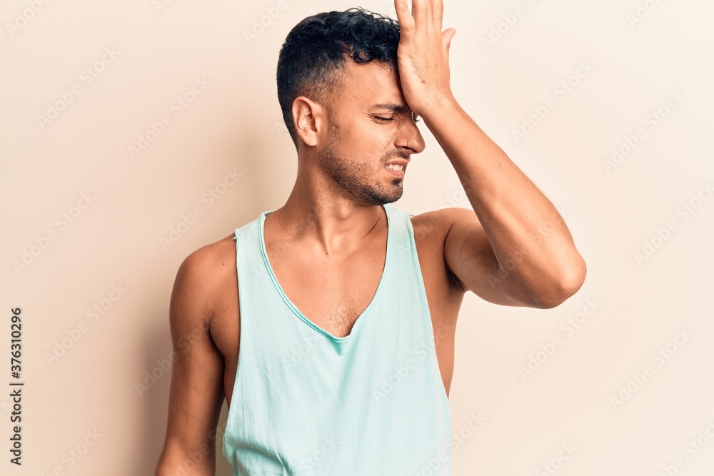 Young hispanic man wearing casual clothes surprised with hand on head for mistake, remember error. forgot, bad memory concept. Young hispanic man wearing casual clothes surprised with hand on head for mistake, remember error. forgot, bad memory concept.