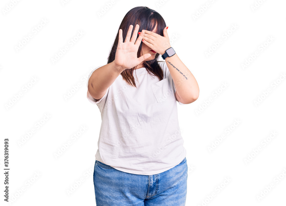 Young plus size woman wearing casual clothes covering eyes with hands and doing stop gesture with sad and fear expression. embarrassed and negative concept. Young plus size woman wearing casual clothes covering eyes with hands and doing stop gesture with sad and fear expression. embarrassed and negative concept.