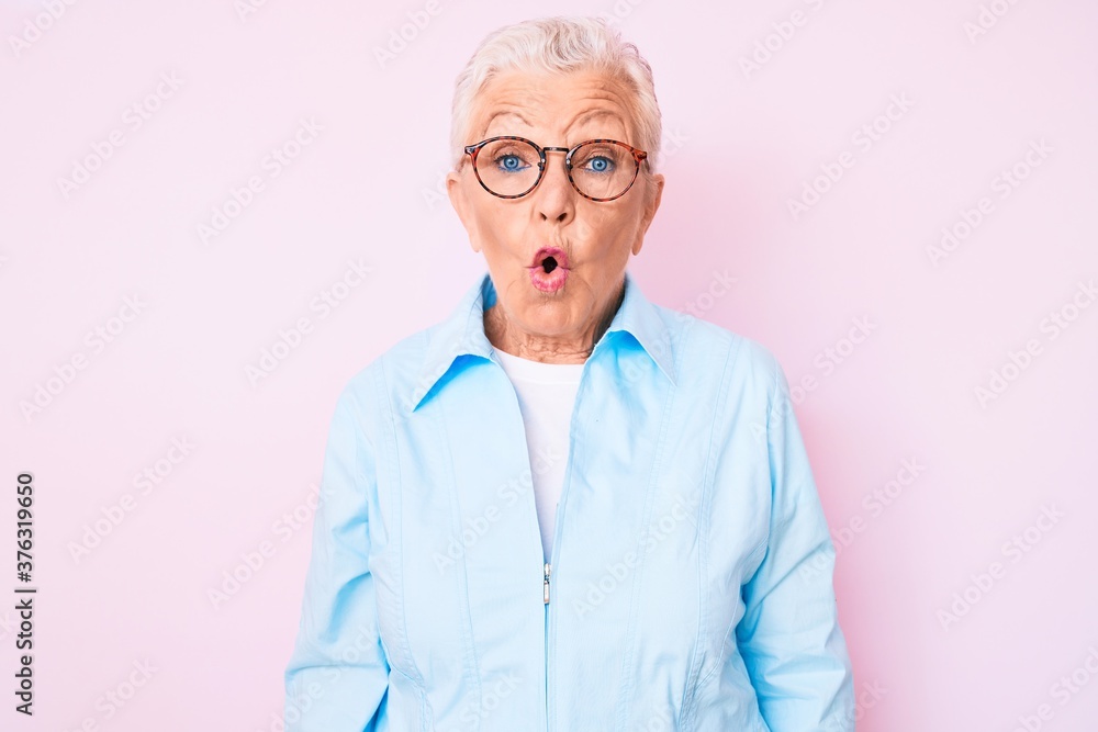 Senior beautiful woman with blue eyes and grey hair wearing glasses scared and amazed with open mouth for surprise, disbelief face Senior beautiful woman with blue eyes and grey hair wearing glasses scared and amazed with open mouth for surprise, disbelief face