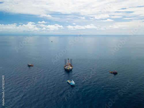 Offshore jack up rig and tow vessels during the rig move operation at the offshore location