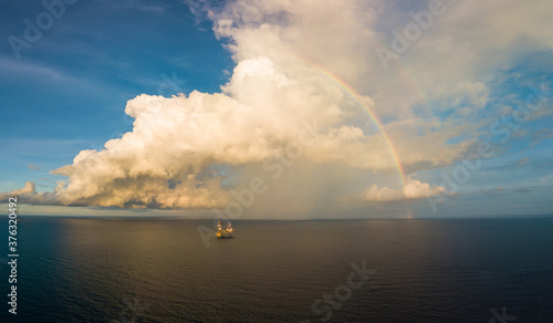 Aerial panorama view from a drone of an offshore jack up rig with beautiful sky and rainbow at the offshore location