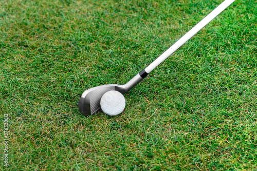 Golf clubs on the green grass