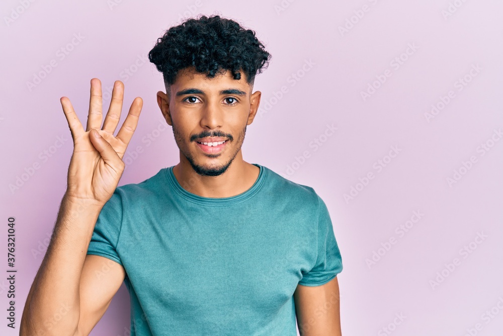 Young arab handsome man wearing casual clothes showing and pointing up with fingers number four while smiling confident and happy. Young arab handsome man wearing casual clothes showing and pointing up with fingers number four while smiling confident and happy.