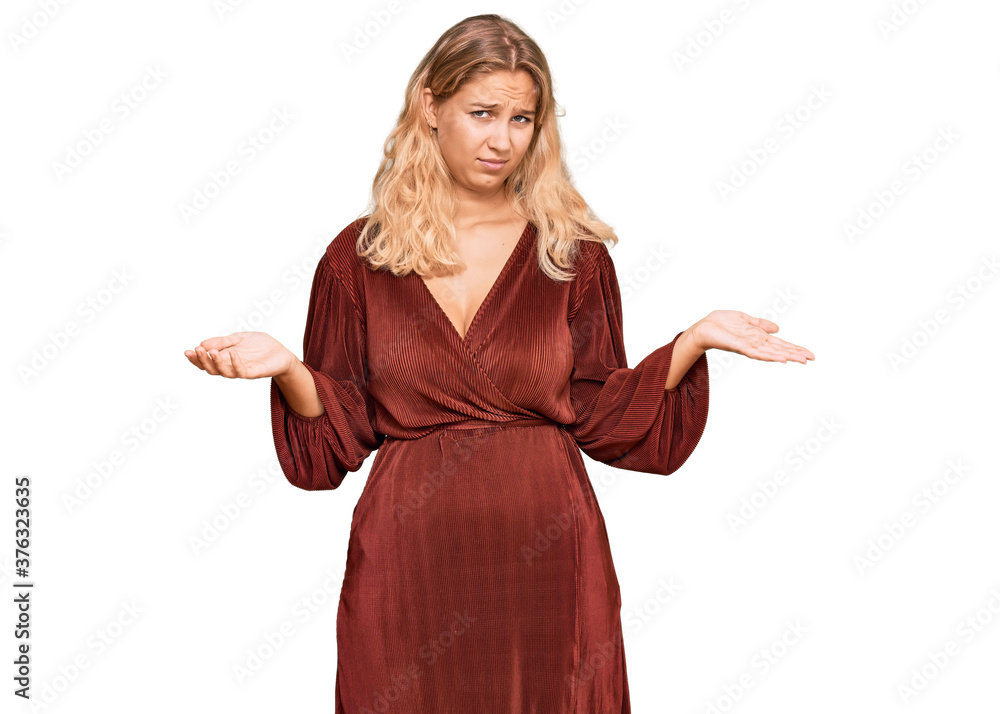 Young blonde girl wearing casual clothes clueless and confused expression with arms and hands raised. doubt concept. Young blonde girl wearing casual clothes clueless and confused expression with arms and hands raised. doubt concept.