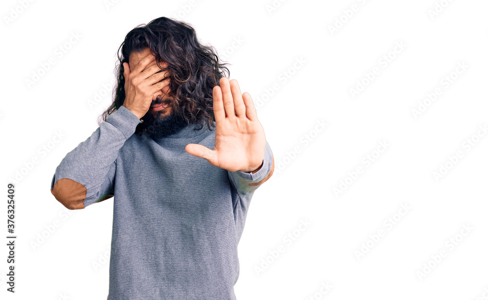 Young arab man wearing casual clothes covering eyes with hands and doing stop gesture with sad and fear expression. embarrassed and negative concept. Young arab man wearing casual clothes covering eyes with hands and doing stop gesture with sad and fear expression. embarrassed and negative concept.