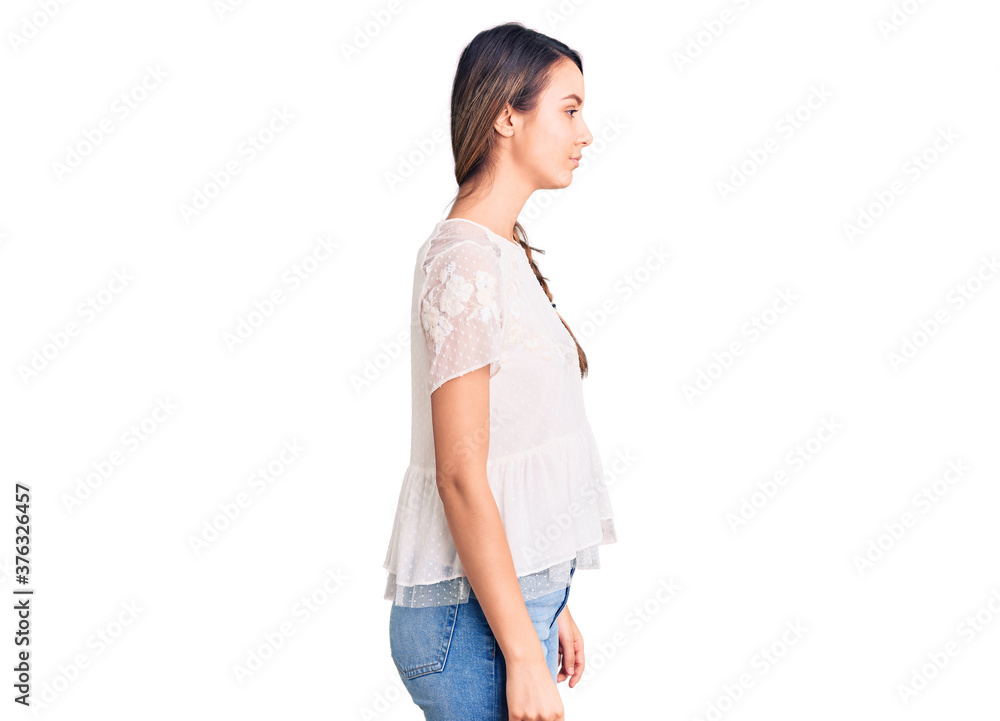 Young beautiful girl wearing casual t shirt looking to side, relax profile pose with natural face with confident smile. Young beautiful girl wearing casual t shirt looking to side, relax profile pose with natural face with confident smile.