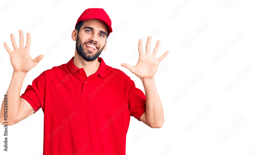 Young handsome man with beard wearing delivery uniform showing and pointing up with fingers number ten while smiling confident and happy. Young handsome man with beard wearing delivery uniform showing and pointing up with fingers number ten while smiling confident and happy.