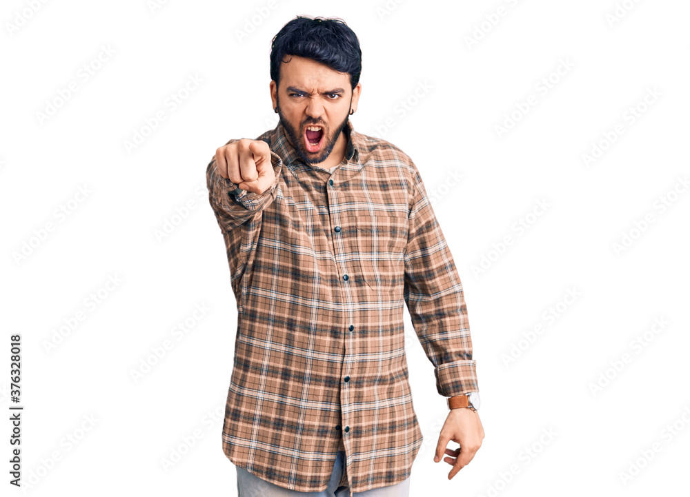 Young hispanic man wearing casual clothes pointing displeased and frustrated to the camera, angry and furious with you Young hispanic man wearing casual clothes pointing displeased and frustrated to the camera, angry and furious with you