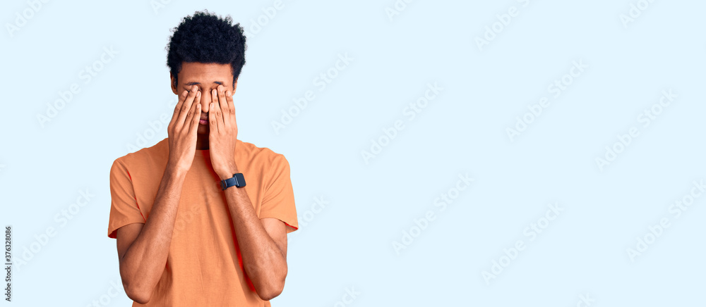 Fototapeta premium Young african american man wearing casual clothes rubbing eyes for fatigue and headache, sleepy and tired expression. vision problem